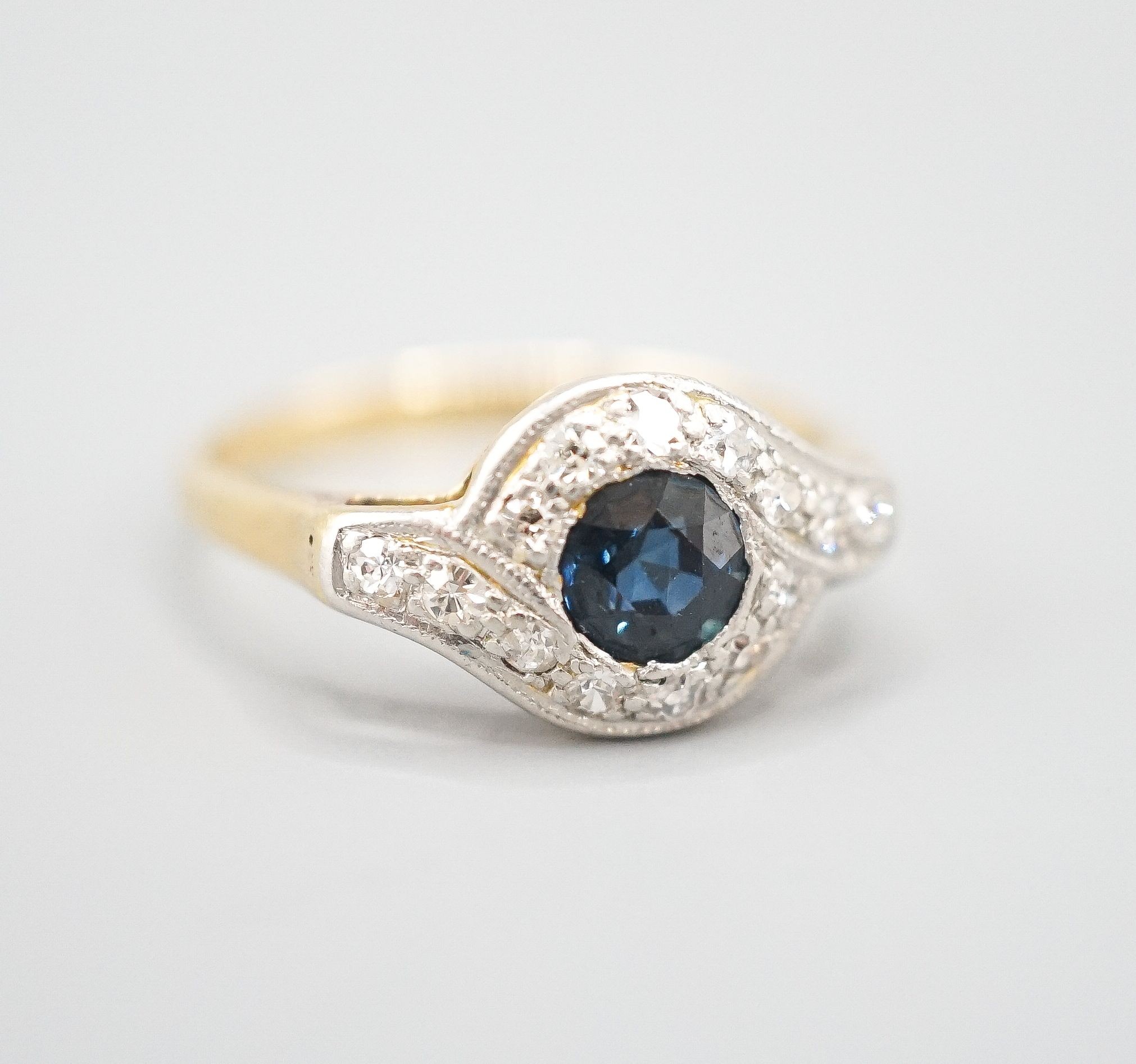 An early to mid 20th century 18ct, sapphire and diamond set cluster ring, size N/O, gross weight 2.6 grams.